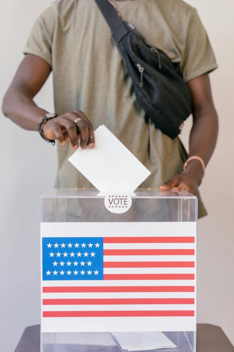 Man Putting Paper on Ballot Box